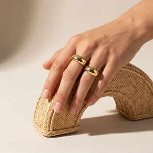 Gold rings on woven texture