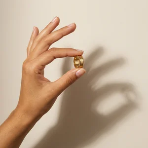 Gold ring held in warm light