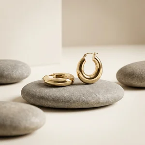 Gold hoops on river stones