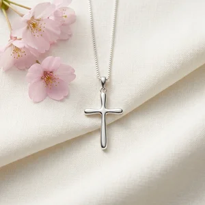 Silver cross on white fabric