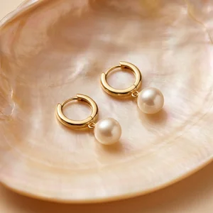 Gold pearl hoops in shell