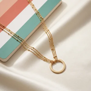 Layered gold necklace on silk