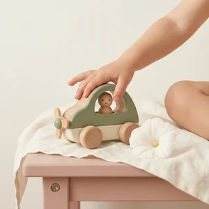 Wooden toy car with child's hand
