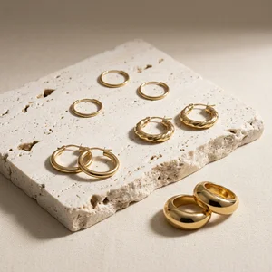 Gold jewelry on textured stone