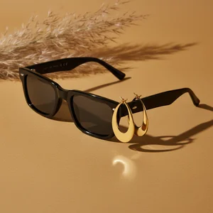 Chic sunglasses and gold earrings