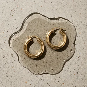 Gold hoops on concrete with water