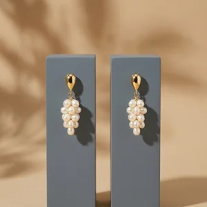 Modern pearl earrings on gray stands