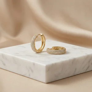 Luxury gold hoops on marble