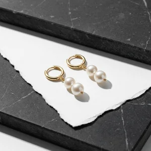 Elegant pearl earrings on marble