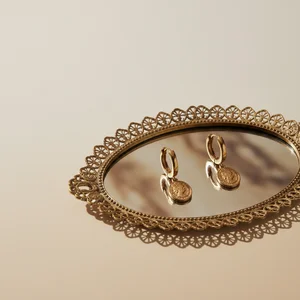 Golden earrings with dried foliage