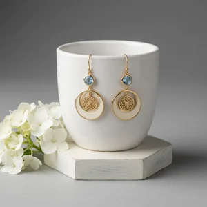 Elegant earrings on ceramic cup