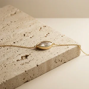 Minimalist gold necklace on stone