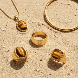 Gold jewelry on beach sand