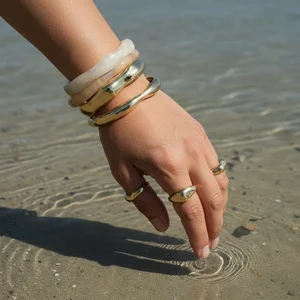 Golden bracelets by the water