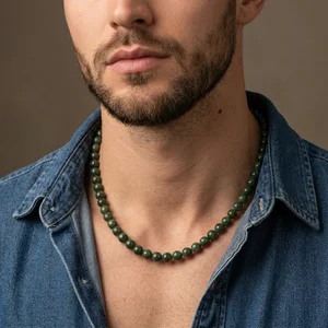 Jade bead necklace on denim