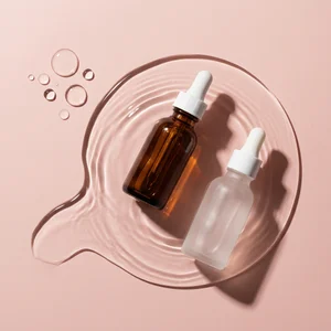 Hydrating serums on pink water