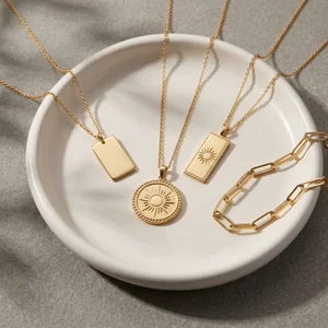 Gold necklaces on ceramic dish