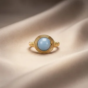 Gold wire ring on satin fabric