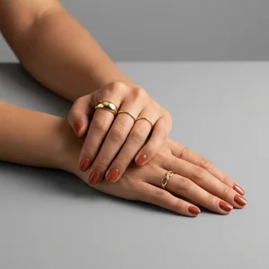 Elegant gold rings on manicured hands