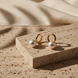 Chic gold earrings on stone