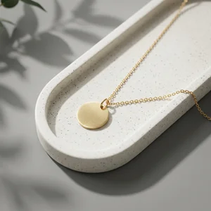 Gold necklace on concrete tray