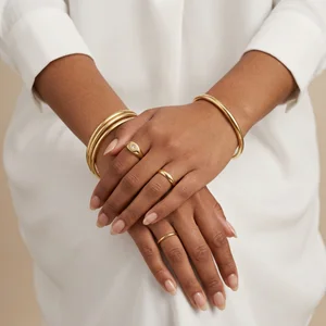 Elegant gold jewelry on hands
