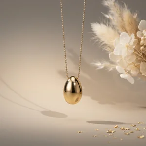 Elegant gold egg necklace display