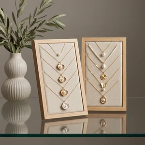 Elegant pearl necklaces on wood display