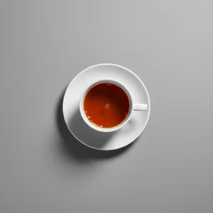 Warm orange tea in white cup
