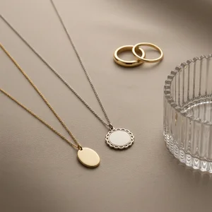 Gold necklaces on beige fabric