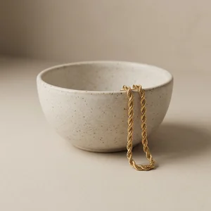 Elegant gold jewelry in ceramic bowl
