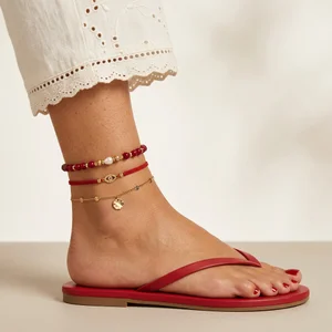 Layered anklets on summer foot