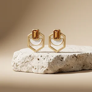 Gold earrings on natural rock