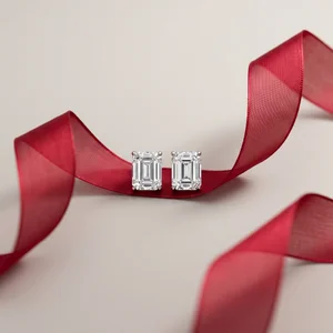Luxury emerald-cut studs on red ribbon