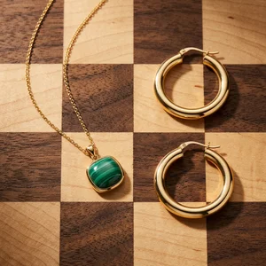Gold jewelry on checkered wood