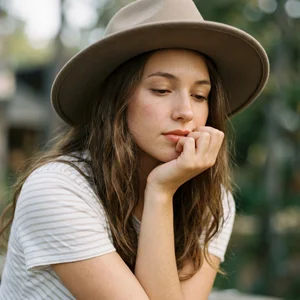 Pensive woman in felt hat