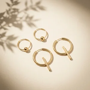 Gold earrings with palm shadow