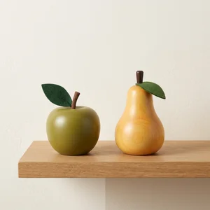 Decorative fruit on wooden shelf