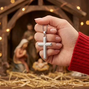 Christmas cross held in hand
