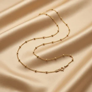 Gold beaded chain on satin