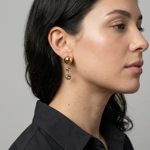 Elegant gold ball earring close-up