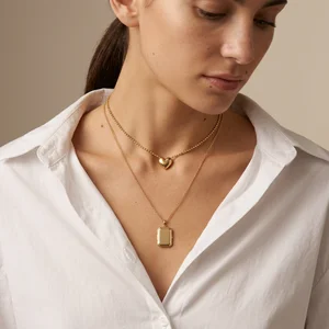 Layered gold necklaces on model