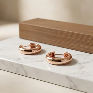 Elegant rose gold hoops on marble