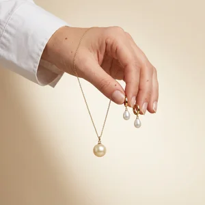 Pearl jewelry held by hand