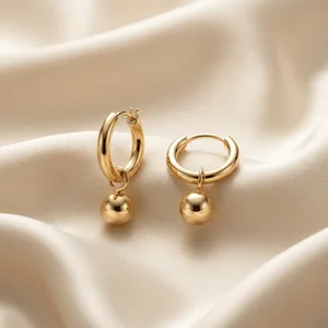 Gold hoop earrings on satin