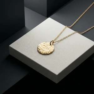 Gold pendant on textured display