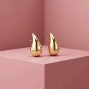 Romantic gold earrings on pink