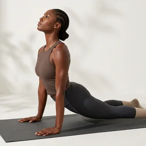 Yoga pose in sun-dappled studio