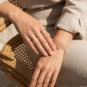 Gold jewelry on woven bag