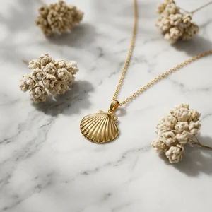 Gold seashell necklace on marble